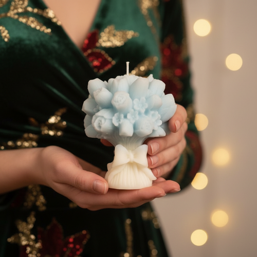 Decorative candle with a Christmas tree and ornaments on a mantelpiece.