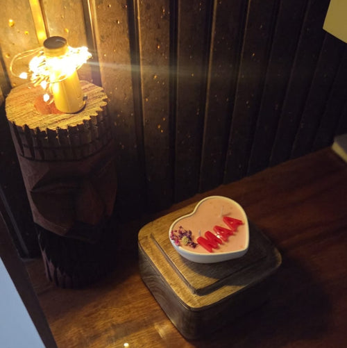 Decorative items on a wooden surface with a candle in the background